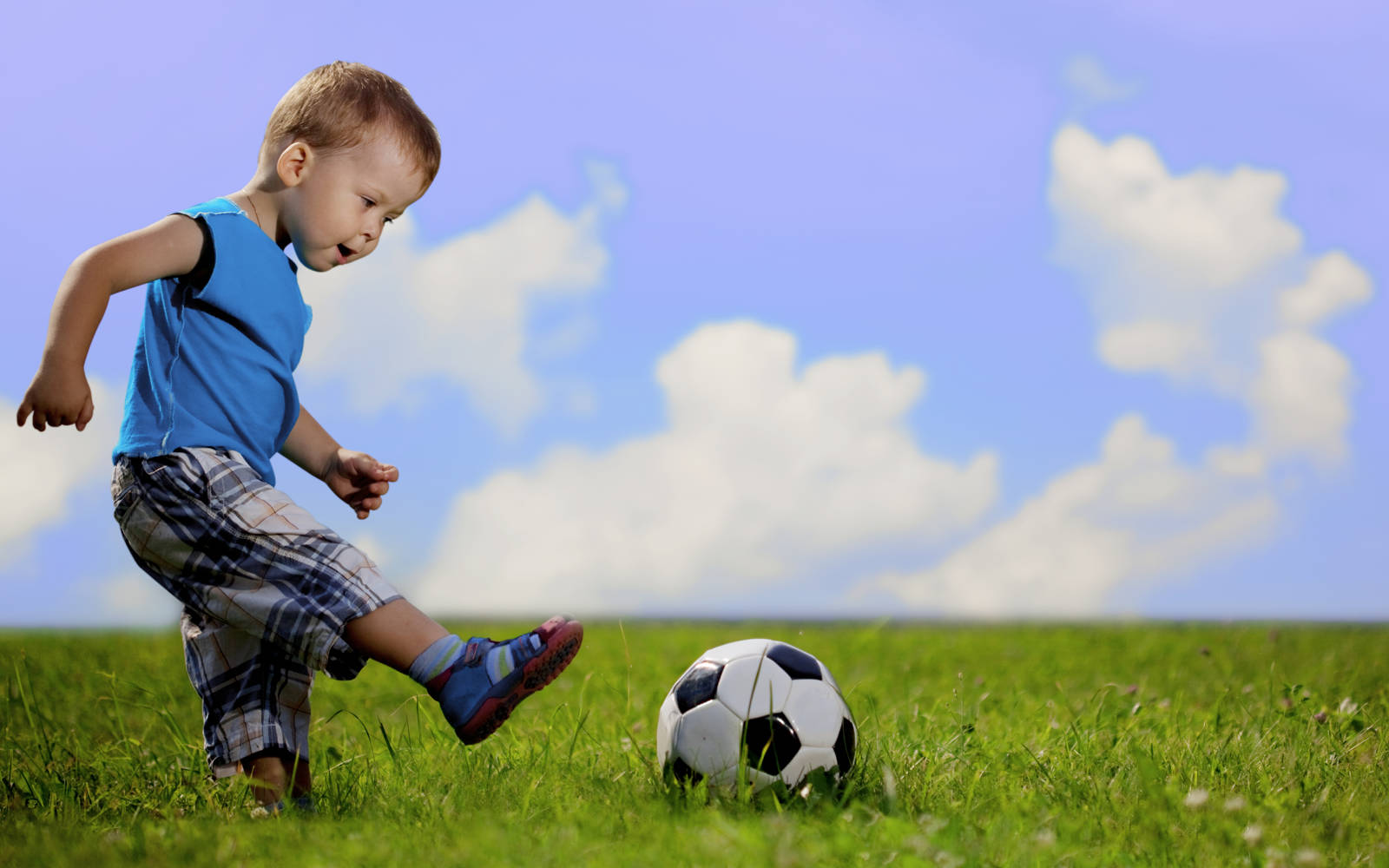 Child kicking a soccer ball