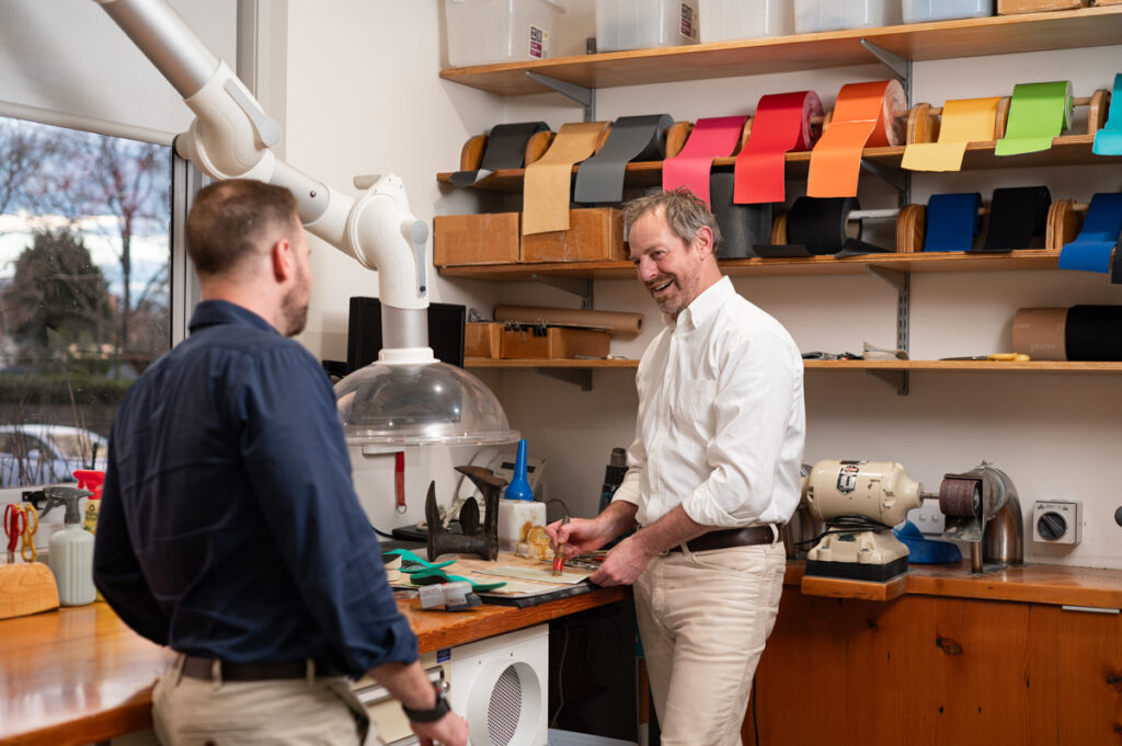 Photograph of our podiatrists working in our custom orthotics workshop
